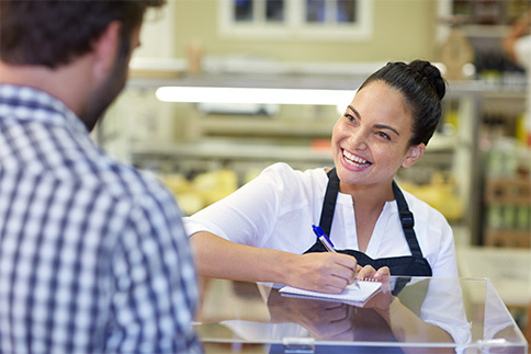 Woman taking order from customer