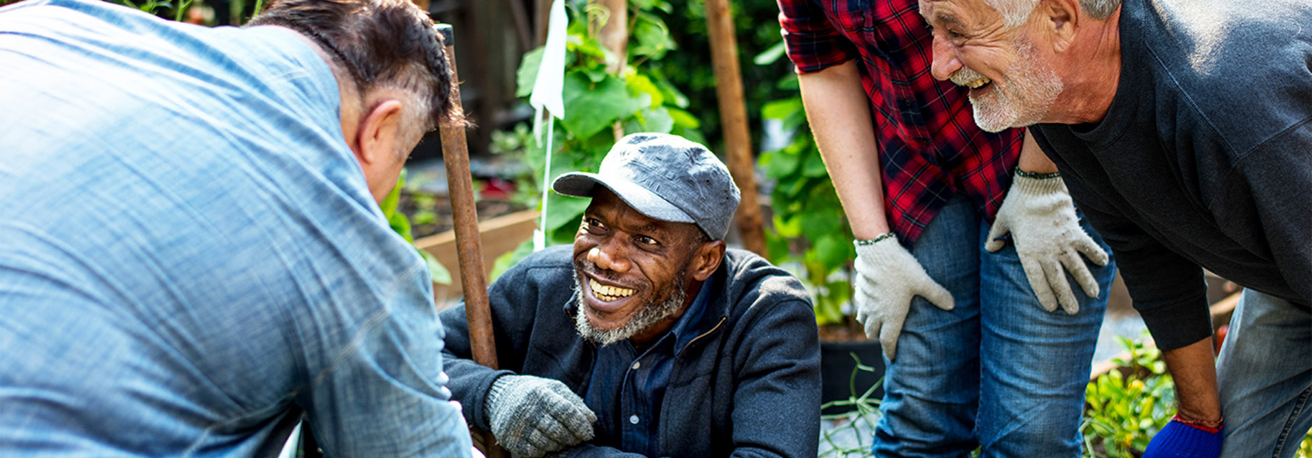 men laughing in community garden